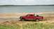 Big Red Ford starting mud drag at shoreline